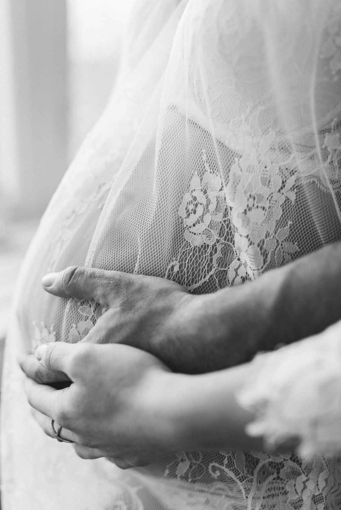Belly of pregnant woman with two hands on it
