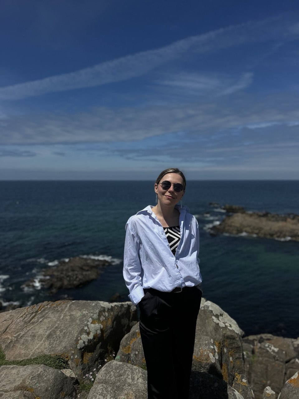 woman blue shirt at the sea side